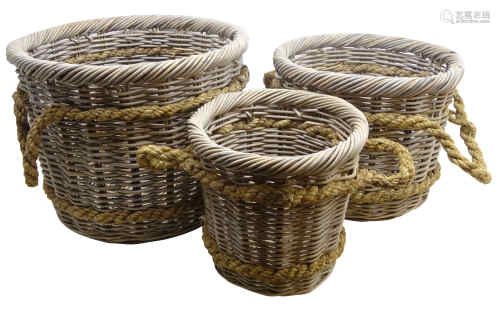 Three graduating wicker log baskets with rope work handles,