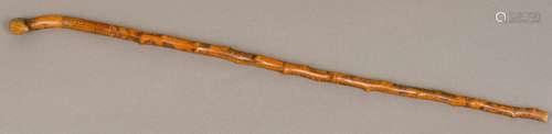 A 19th century Folk Art carved/engraved treen walking stick Decorated in the round with figures,