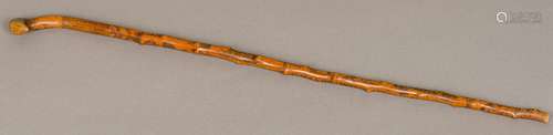 A 19th century Folk Art carved/engraved treen walking stick Decorated in the round with figures,