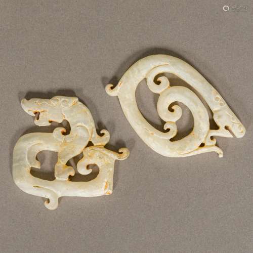 Two Chinese Waring States or Han Dynasty carved hardstone amulets Worked as stylised dragons.