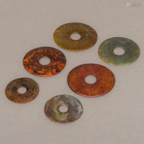 Six Chinese Neolithic carved hardstone bi discs Of typical form. The largest 8.5 cm diameter.