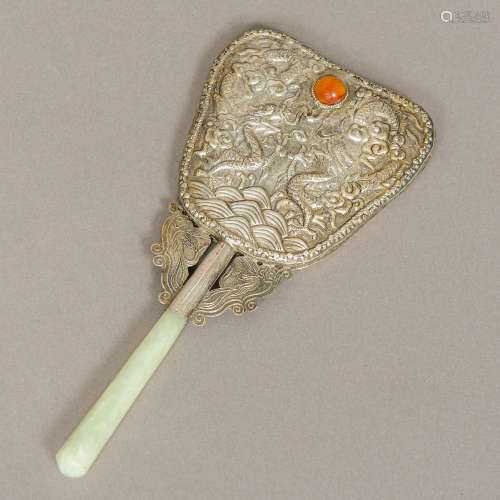 A Chinese jade mounted white metal backed hand mirror Worked with dragons chasing a mineral