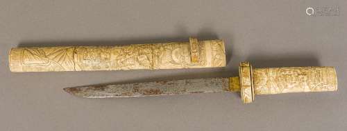 A 19th century Japanese carved bone tanto The handle and scabbard typically worked with figures in