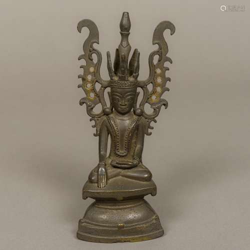 An Eastern bronze model of Buddha Seated in the lotus position with ornate headdress. 20.5 cm high.
