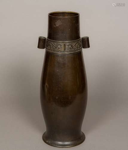 A Chinese bronze arrow vase Of slender baluster form, decorated with a archaistic band. 47 cm high.