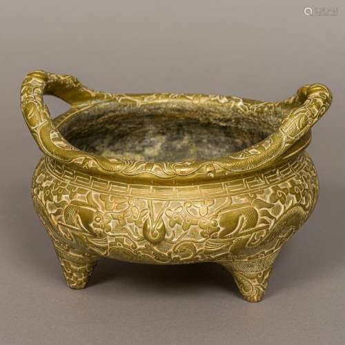 A large Chinese gilt bronze twin handled censer Extensively worked with stylised dragons chasing