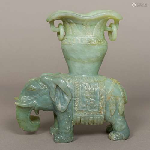 A Chinese carved jade twin handled vase Supported on the figure of an elephant. 22.5 cm high.