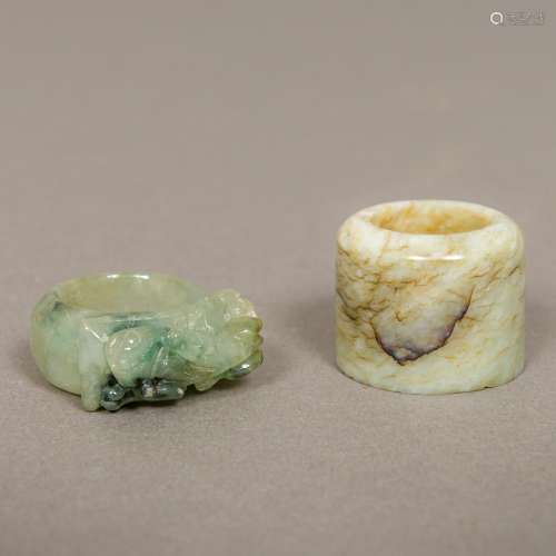 A Chinese carved jade archer's ring Together with a carved jade ring worked with a mythical beast.