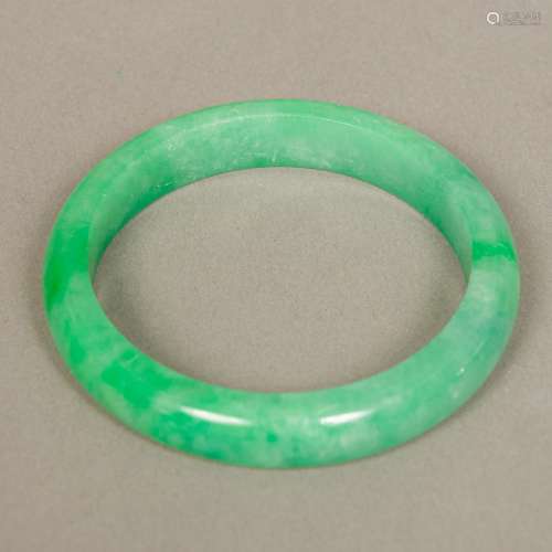 A Chinese carved jade bangle 8 cm diameter.