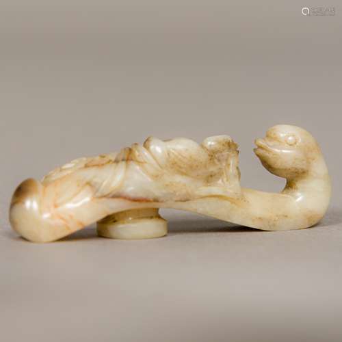 A Chinese carved celadon and russet jade belt hook Worked as an Asiatic duck and its chick.