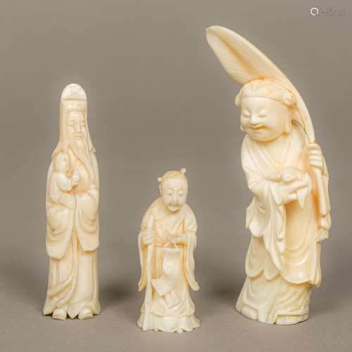 A small late 19th century Chinese carved ivory model of a sagely figure holding a small