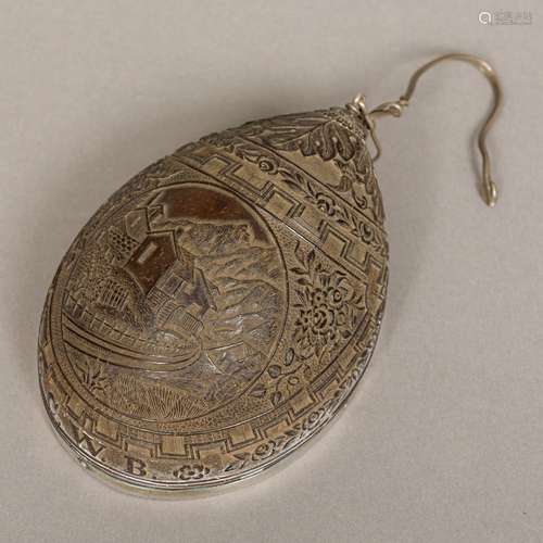 A 19th century white metal mounted well carved coconut pendant Worked with an alpine scene within