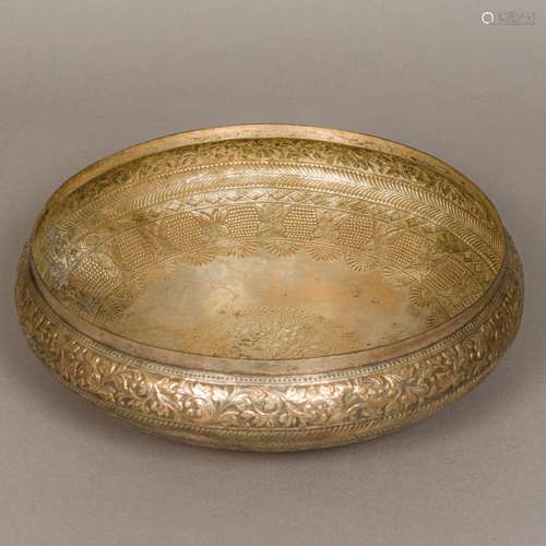 A large unmarked Indian silver bowl Of shallow design with floral repousse bandings above a band of