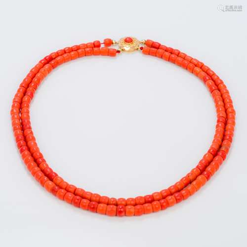 A two strand coral bead necklace Set with a cabochon mounted gold clasp. 49.5 cm long.