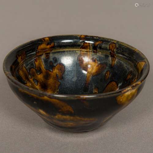 A Chinese Song Dynasty pottery bowl With allover treacle glaze. 12 cm diameter.