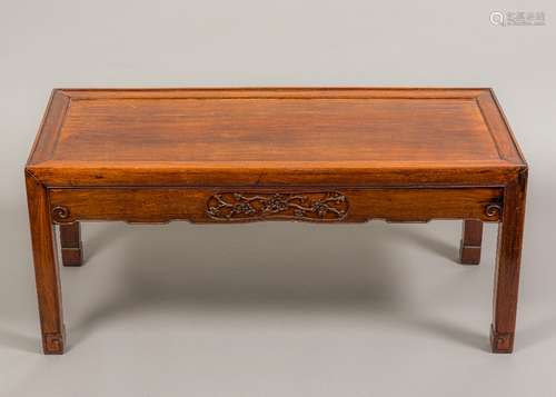 A Chinese huan hua li wood low table The panelled top above a prunus blossom carved long frieze