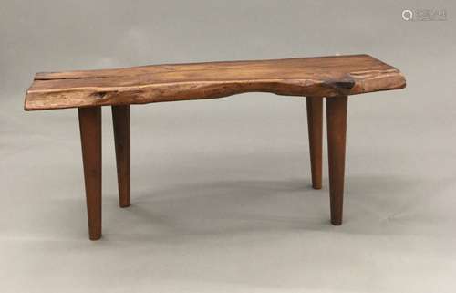 A Reynolds of Ludlow yewwood coffee table The naturalistic plank top supported on tapering legs,