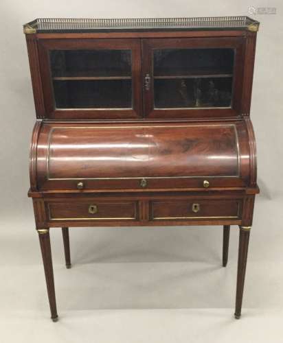 A 19th century brass mounted mahogany cylinder bureau The upper section with three-quarter pierced