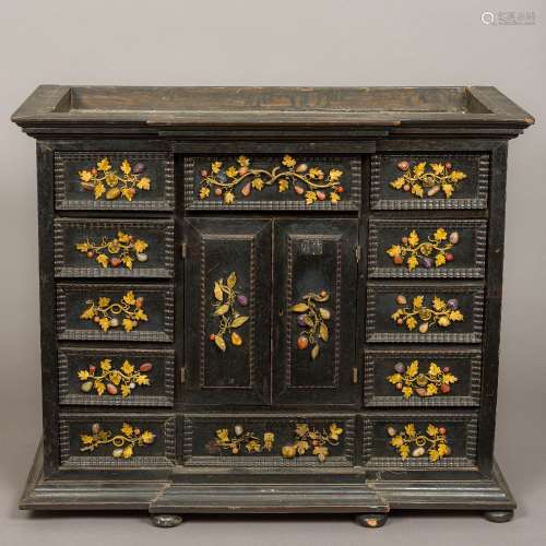 An 18th century ebonised table cabinet The breakfront cornice above an arrangement of twelve