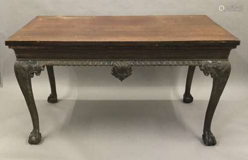 A 19th century mahogany serving table The rectangular top above the frieze with central foliate and