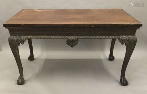 A 19th century mahogany serving table The rectangular top above the frieze with central foliate and