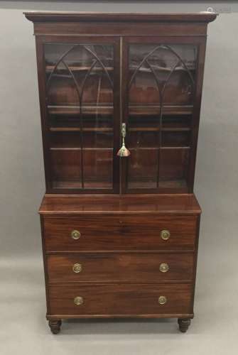 A 19th century mahogany secretaire bookcase The moulded cornice above the twin arched glazed doors