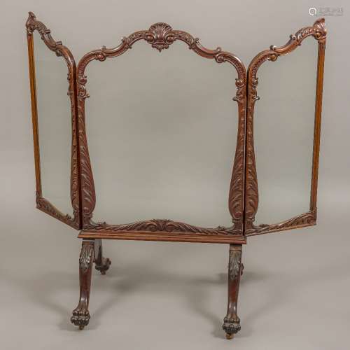 A 19th century mahogany folding fire screen The clear glazed panels set in the shell,
