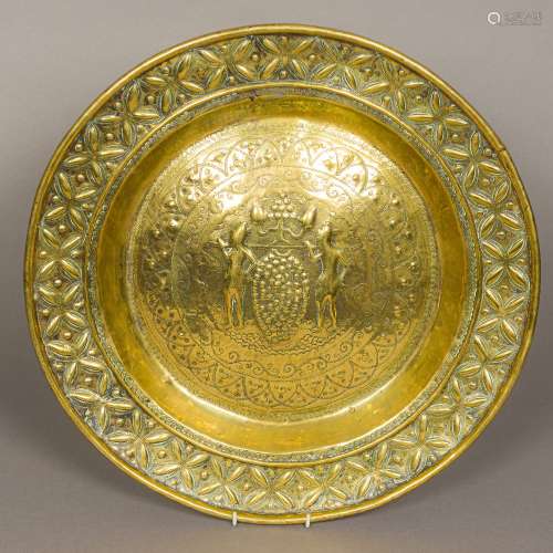 An antique, possibly 17th/18th century brass alms dish With repousse decoration,