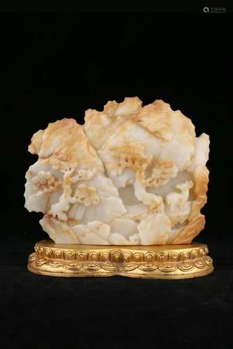 A CARVED WHITE JADE BOULDER AND STAND