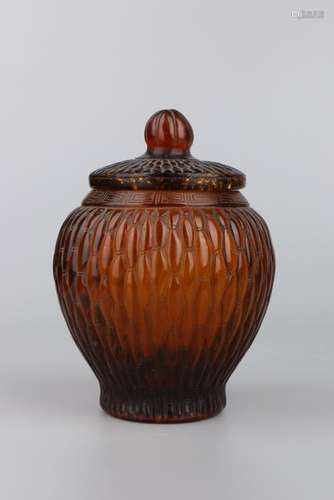 AN AMBER GLASS JAR AND COVER.ANTIQUE