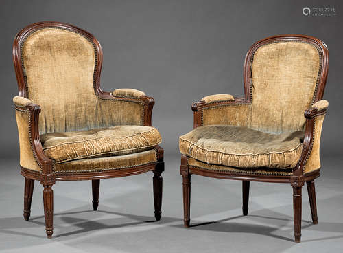 Two Antique Louis XVI-Style Carved Mahogany Bergeres , each with molded crest rail, scrolled arms,