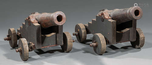 Pair of Decorative Cast Iron and Wood Cannons , 20th c., working wheels, tube l. 16 in., overall