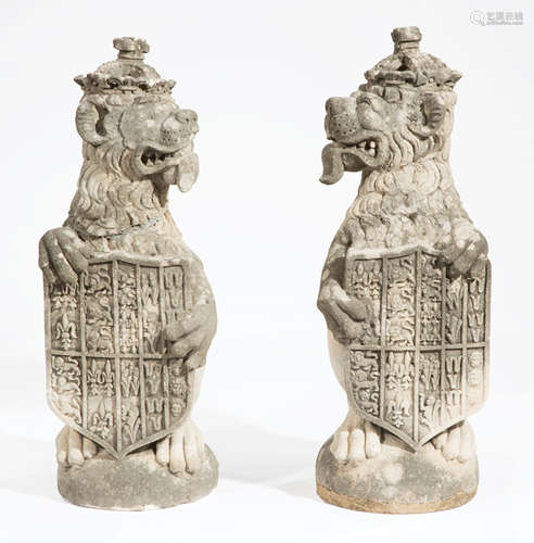 Pair of Antique Cast Stone Opposing Heraldic Lions , each wearing a crown and holding a royal