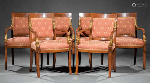 Six Restauration Carved and Gilded Fruitwood Armchairs , padded back, shaped arms terminating in