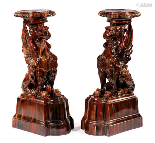 Pair of Continental Majolica Pedestals , late 19th c., modeled as griffins on shaped plinths,