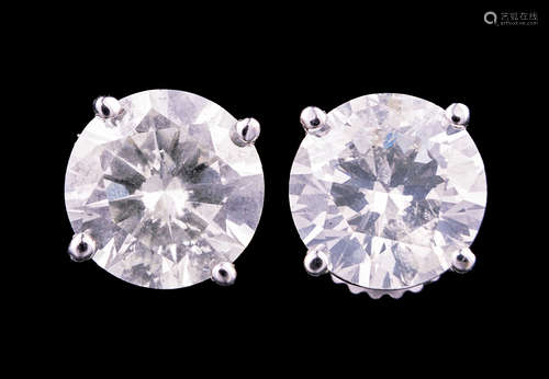 Pair of 18 kt. White Gold and Diamond Stud Earrings , two prong set round brilliant cut diamonds,