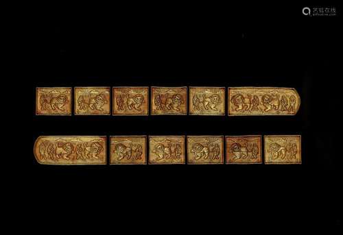 A MAGNIFICENT GROUP OF 12 GOLDEN BELT PLAQUES