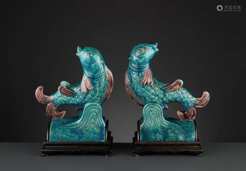 TWO AUBERGINE AND TURQUOISE GLAZED ‘FISH’ ROOF TIL…