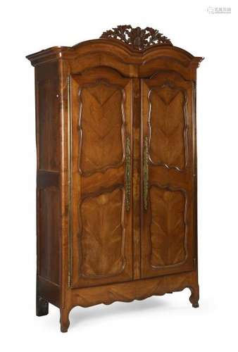 Armoire en merisier mouluré et sculpté ouvrant par deux portes à encadrement de [...]