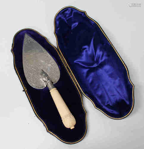 A late Victorian silver presentation trowel with engraved foliate scrolls and presentation