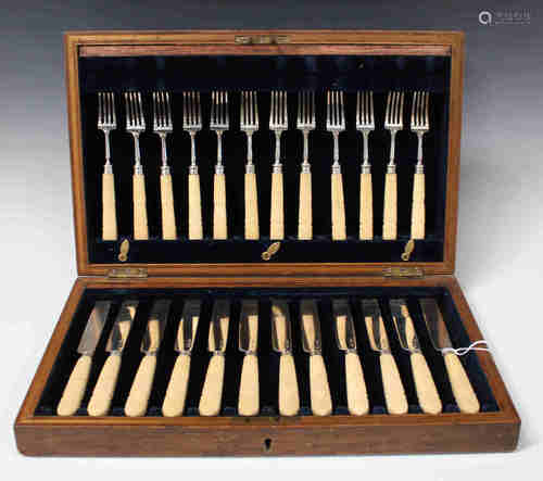 A set of twelve George IV silver fruit knives and forks with carved ivory handles, Sheffield 1824 by