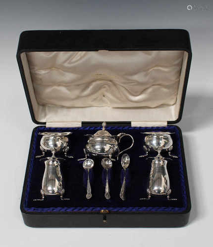 An Edwardian silver five-piece condiment set, comprising mustard, pair of salts and pair of peppers,