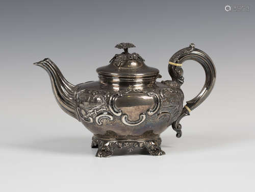 A Victorian silver teapot with hinged lid and flower finial, the compressed circular body embossed