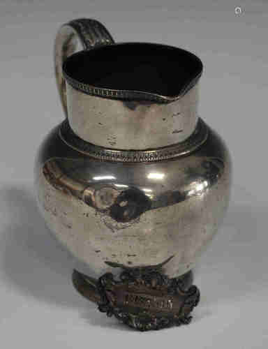 A George V silver jug with foliate capped scroll handle, Sheffield 1912 by James Dixon & Sons,