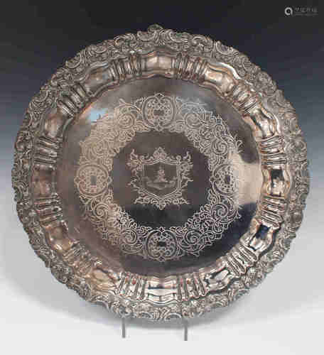 A Sheffield plate salver, circa 1830, the centre engraved with a crest within a foliate surround,