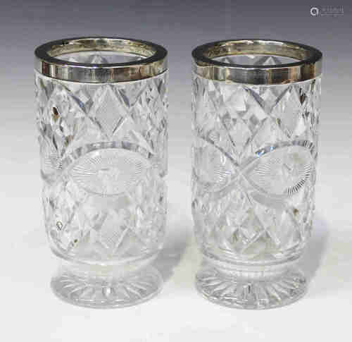 A pair of George V silver mounted cut glass vases, each with silver rim on a circular foot,