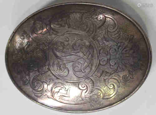 An 18th century silver oval tobacco box and cover, the cover engraved with a monogram framed by a