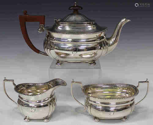 A George VI silver three-piece tea set of cushion form with gadrooned rim and bun feet, comprising