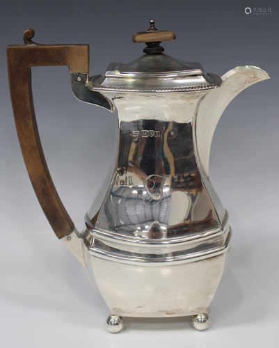 A George VI silver hot water pot of rectangular cushion form with gadrooned rim, on ball feet,