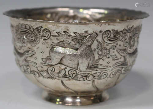 A late Victorian silver bowl, chased with a stag, two hunting dogs and two ducks within a band of